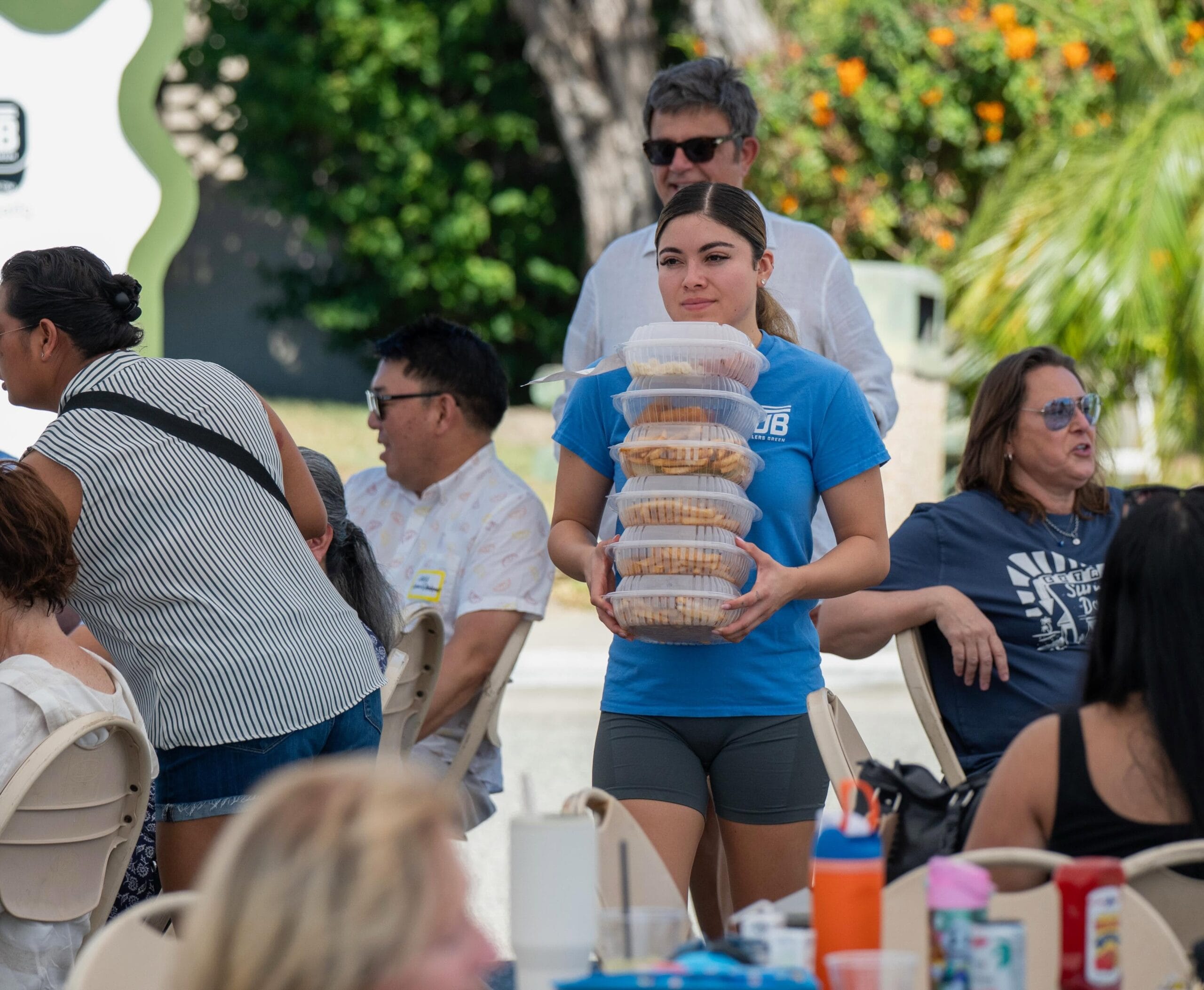 Pub employee carrying meals to guests on the patio during Air Show Weekend 2026.